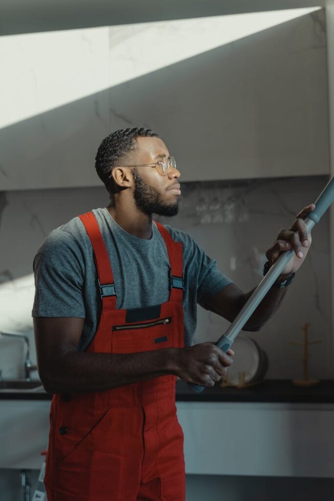 A Bearded Man Wearing an Overall Cleaning